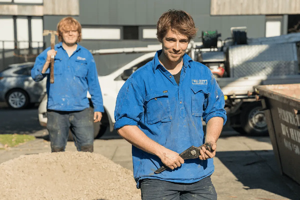two plumbers from vic city plumbing uniform holding tools ready to work